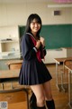 A woman in a school uniform posing for a picture.