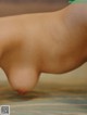 A close up of a person's foot on a bed.