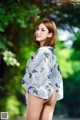 A woman in a blue and white kimono posing for the camera.