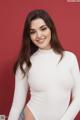 A woman in a white bodysuit posing for a picture.