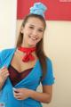 A woman in a blue shirt and red scarf posing for a picture.